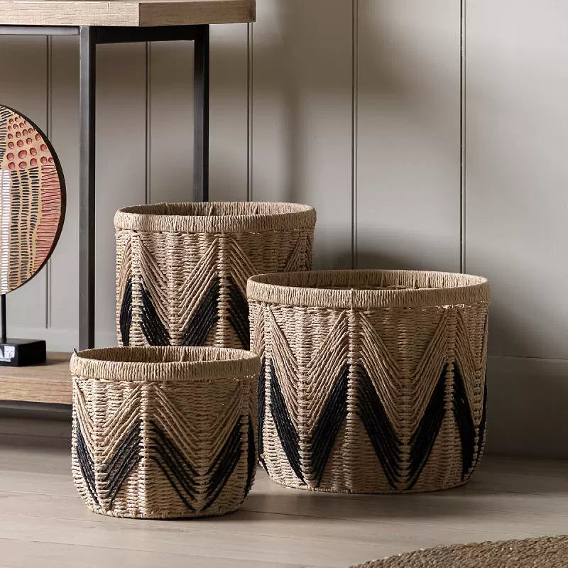 Natural handwoven paper rope baskets placed beside console table for decorative storage use.