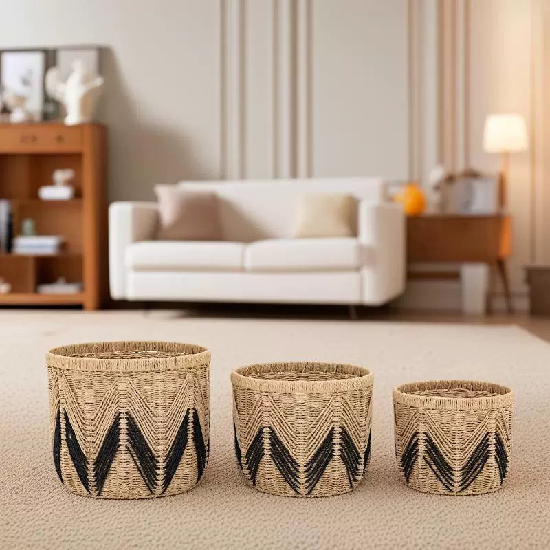 Trio of woven paper rope baskets in a cozy living room setting with modern furniture.