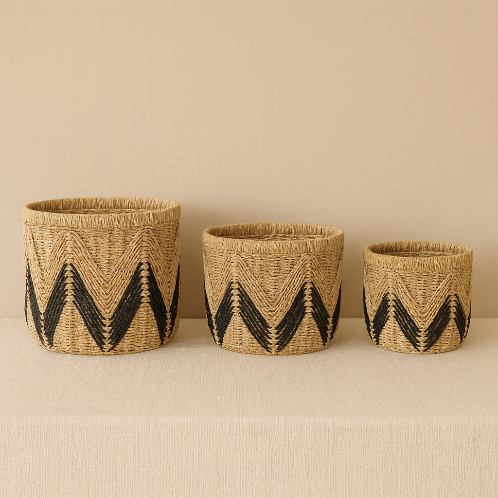 Three natural paper rope baskets with black chevron pattern arranged neatly against a beige background.