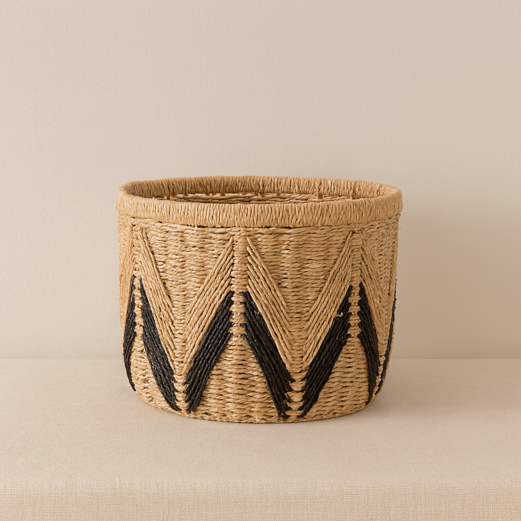 Single large woven paper rope basket with bold black chevron design, placed on beige surface.